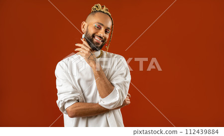 Make up artist Black latin gay man isolated on red 112439884