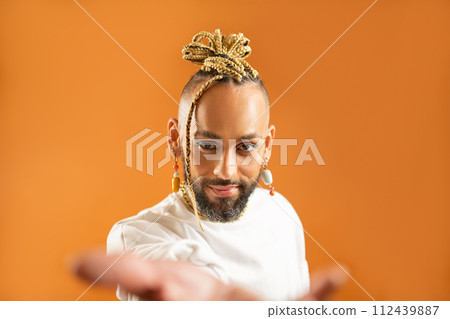 Black latin gay man outstretching empty hand 112439887