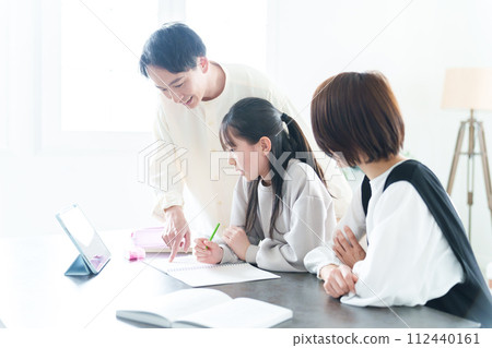 Girl studying, parents teaching 112440161