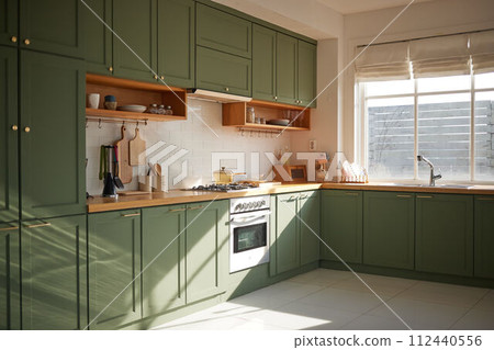 a sun-filled green kitchen a sun-filled green kitchen 112440556