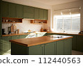 a sun-filled green kitchen 112440563