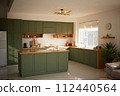 a sun-filled green kitchen 112440564