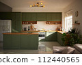 a sun-filled green kitchen 112440565