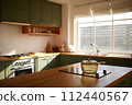 a sun-filled green kitchen 112440567