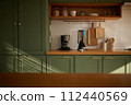 a sun-filled green kitchen 112440569