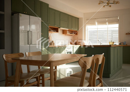 a sun-filled green kitchen 112440571