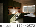 a sun-filled green kitchen 112440572