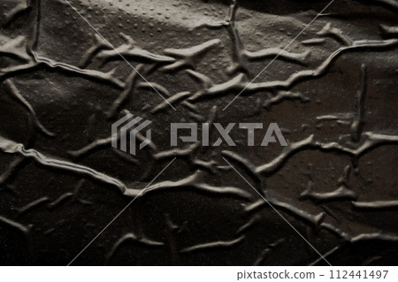 black crumpled and creased plastic bag texture background black crumpled and creased plastic bag texture background 112441497