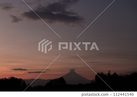 Mt. Fuji is covered with clouds in the distance as the dawn sky turns red. Mt. Fuji is covered with clouds in the distance as the dawn sky turns red. 112441540