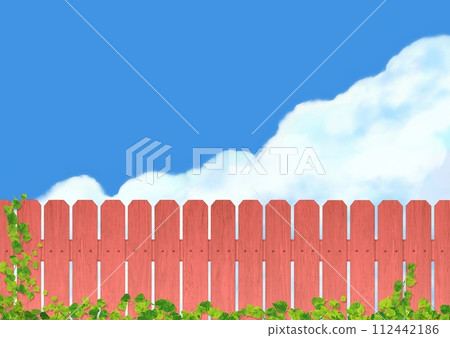 Red wooden fence and blue sky in the background A 112442186