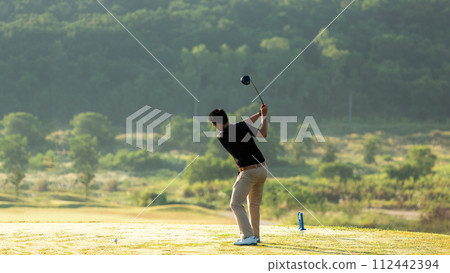 Golfer sport course golf ball fairway. People lifestyle man playing game golf tee off on the green grass.  112442394