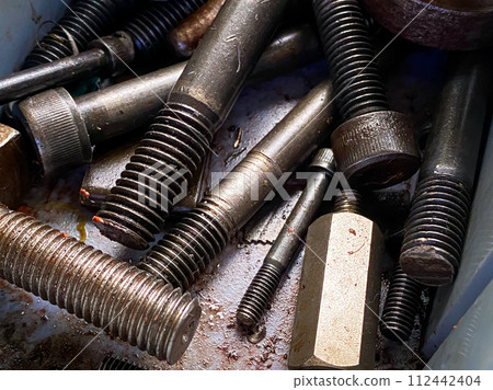 Detail of different metallic bolts and nuts in the toolbox Detail of different metallic bolts and nuts in the toolbox 112442404