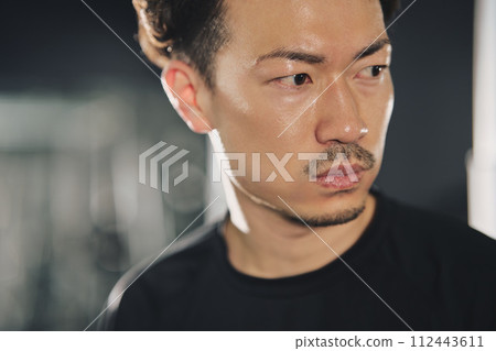 A man with a serious expression at the training gym 112443611