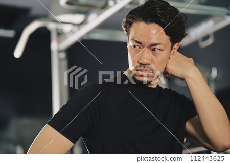 A man with a serious expression at the training gym 112443625
