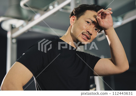 A man with a serious expression at the training gym A man with a serious expression at the training gym 112443631