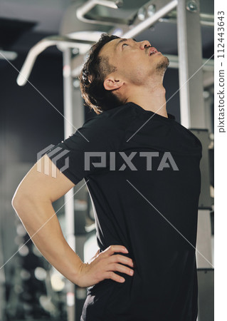 A man with a serious expression at the training gym A man with a serious expression at the training gym 112443643