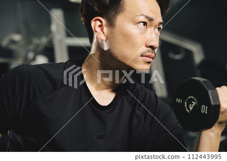 Man doing dumbbell training at the gym Man doing dumbbell training at the gym 112443995