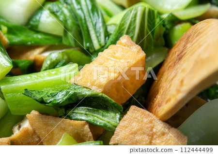 Stir-fried bok choy and tofu, cooking scene. 112444499