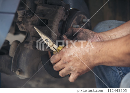 Close up Man hands fixing Car machinery vehicle mechanical service. Mechanic man hands repairing car auto repair shop. open vehicle hood checking up auto mobile. Vehicle Car maintenance engineer. 112445305