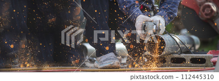 Banner Men hands wear protective glove Hot flame metal work cut fire iron workshop. Locksmith cut metal process. Construction Worker hands using Welding machinery iron metal sparking with copy space 112445310