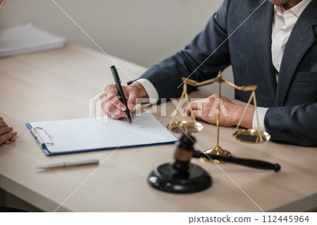 Asian lawyer man working on table office Writing a document, law and justice concept. 112445964