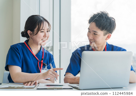 Essential workers men and women having a meeting 112445984