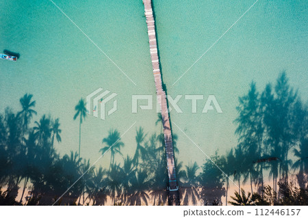 Beach with clear blue sea and palm tree shadows 112446157