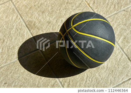 basketball placed on the dirt floor 112446364