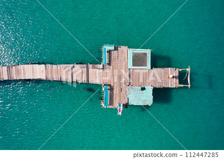 Wooden bridge at the beach and clear blue water 112447285