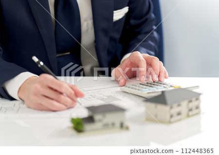 Businessman calculating the floor plan of real estate Businessman calculating the floor plan of real estate 112448365