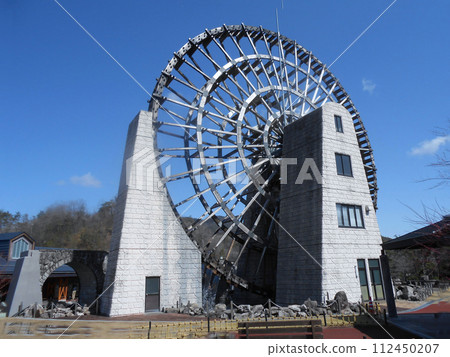 Giant wooden waterwheel and blue sky at Roadside Station Obaachanichi Yamaoka, Ena City, Gifu Prefecture 112450207
