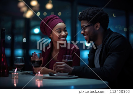 Amidst a warm restaurant ambiance, a happy couple in love shares smiles and laughter, their connection evident in the joyous atmosphere of shared moment and romantic bliss Amidst a warm restaurant ambiance, a happy couple in love shares smiles and laughter, their connection evident in the joyous atmosphere of shared moment and romantic bliss 112450503