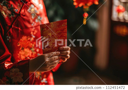 Chinese new year celebration, Cropped shot of hand receiving red envelopes from their parent 112451472