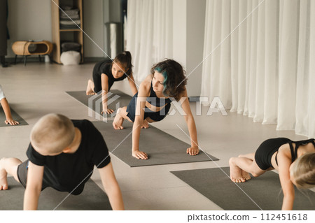 Children do Yoga in the fitness room. Children's gymnastics 112451618