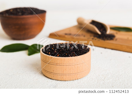 quinoa seeds in bowl and spoon on colored background. Healthy kinwa in small bowl. Healthy superfood 112452413