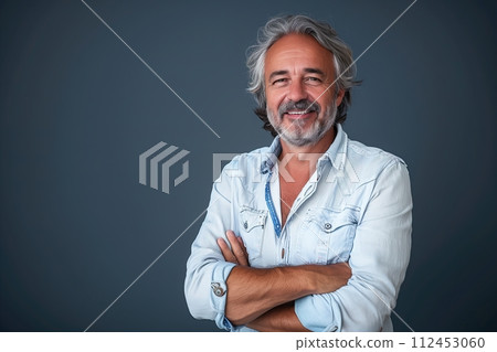 A man with a beard and mustache is smiling and wearing a blue shirt 112453060