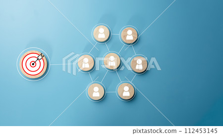 Circular wood with printed target icons and business symbols on light blue background, business goals and objectives concept, business competition, Customer relationship management concept. Circular wood with printed target icons and business symbols on light blue background, business goals and objectives concept, business competition, Customer relationship management concept. 112453145