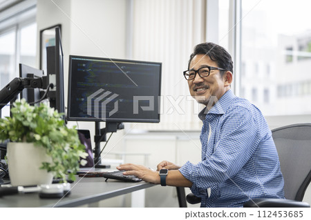 Image of a smiling veteran engineer in his 50s Image of a smiling veteran engineer in his 50s 112453685