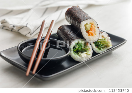 Sushi rolls on Plate with bowl of soy sauce and chopsticks. 112453740