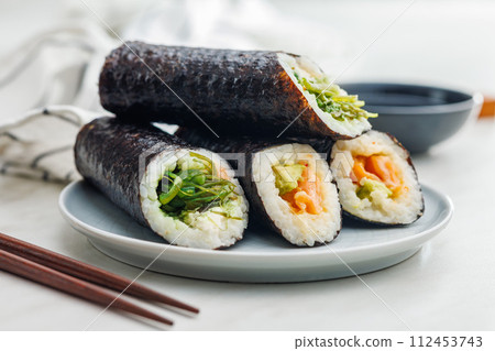 Sushi rolls on Plate with bowl of soy sauce and chopsticks. 112453743