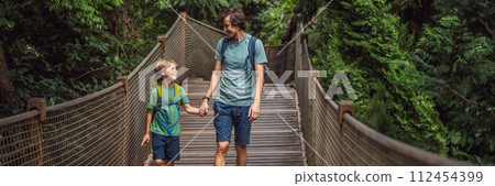 father and son tourists in Rope bridge in Yildiz Park. Besiktas, Istanbul, Turkey. Turkiye. Traveling with kids concept BANNER, LONG FORMAT father and son tourists in Rope bridge in Yildiz Park. Besiktas, Istanbul, Turkey. Turkiye. Traveling with kids concept BANNER, LONG FORMAT 112454399
