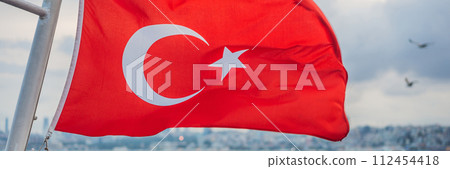 Turkish flag flying in the wind against the background of the sea and the coast BANNER, LONG FORMAT 112454418