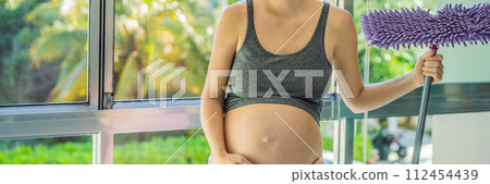 Pregnant woman washes the floor and is tired. Tired pregnant woman having pain in back while she is cleaning her house BANNER, LONG FORMAT Pregnant woman washes the floor and is tired. Tired pregnant woman having pain in back while she is cleaning her house BANNER, LONG FORMAT 112454439