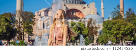 BANNER, LONG FORMAT Woman enjoy beautiful view on Hagia Sophia Cathedral, famous islamic Landmark mosque, Travel to Istanbul, Turkey. Sunny day architecture and Hagia Sophia Museum, in Eminonu BANNER, LONG FORMAT Woman enjoy beautiful view on Hagia Sophia Cathedral, famous islamic Landmark mosque, Travel to Istanbul, Turkey. Sunny day architecture and Hagia Sophia Museum, in Eminonu 112454520