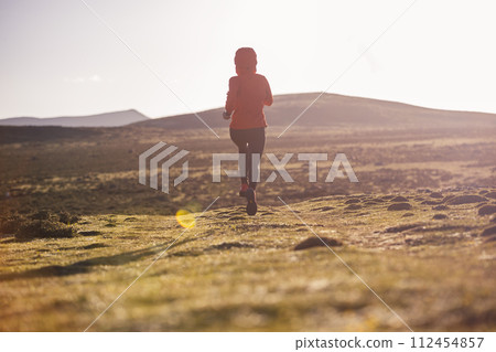 Woman trail runner cross country running to high altitude mountain peak 112454857