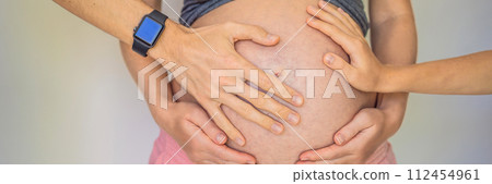 Mother's day, father's day, little cute blond boy touching mom's pregnant belly, husband holding his wife by the belly BANNER, LONG FORMAT Mother's day, father's day, little cute blond boy touching mom's pregnant belly, husband holding his wife by the belly BANNER, LONG FORMAT 112454961