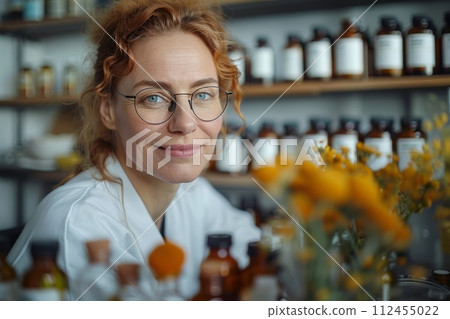 AI-generated content. Portrait of cheerful female doctor of homeopathy or pharmacist in white medical gown working behind a cluttered desk in a cozy office, surrounded by shelves stacked with vials AI-generated content. Portrait of cheerful female doctor of homeopathy or pharmacist in white medical gown working behind a cluttered desk in a cozy office, surrounded by shelves stacked with vials 112455022