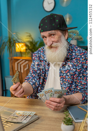 Senior man freelancer counting cash insufficient amount of money financial crisis bankruptcy poverty 112455152
