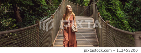 Woman tourist in Rope bridge in Yildiz Park. Besiktas, Istanbul, Turkey. Turkiye BANNER, LONG FORMAT 112455200