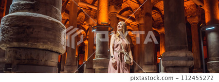 Woman tourist enjoying Beautiful cistern in Istanbul. Cistern - underground water reservoir build in 6th century, Istanbul, Turkey, Turkiye BANNER, LONG FORMAT 112455272